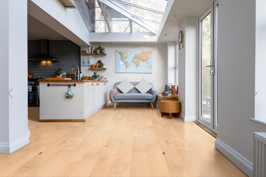 Ladson Bramlett Flooring featured in a sun room next to a kitchen